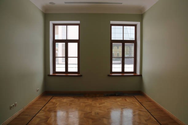 An empty room featuring wooden floors creates a serene and inviting atmosphere.