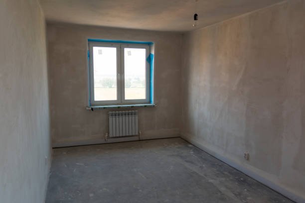 A picture of an apartment undergoing renovations, featuring before our flooring.